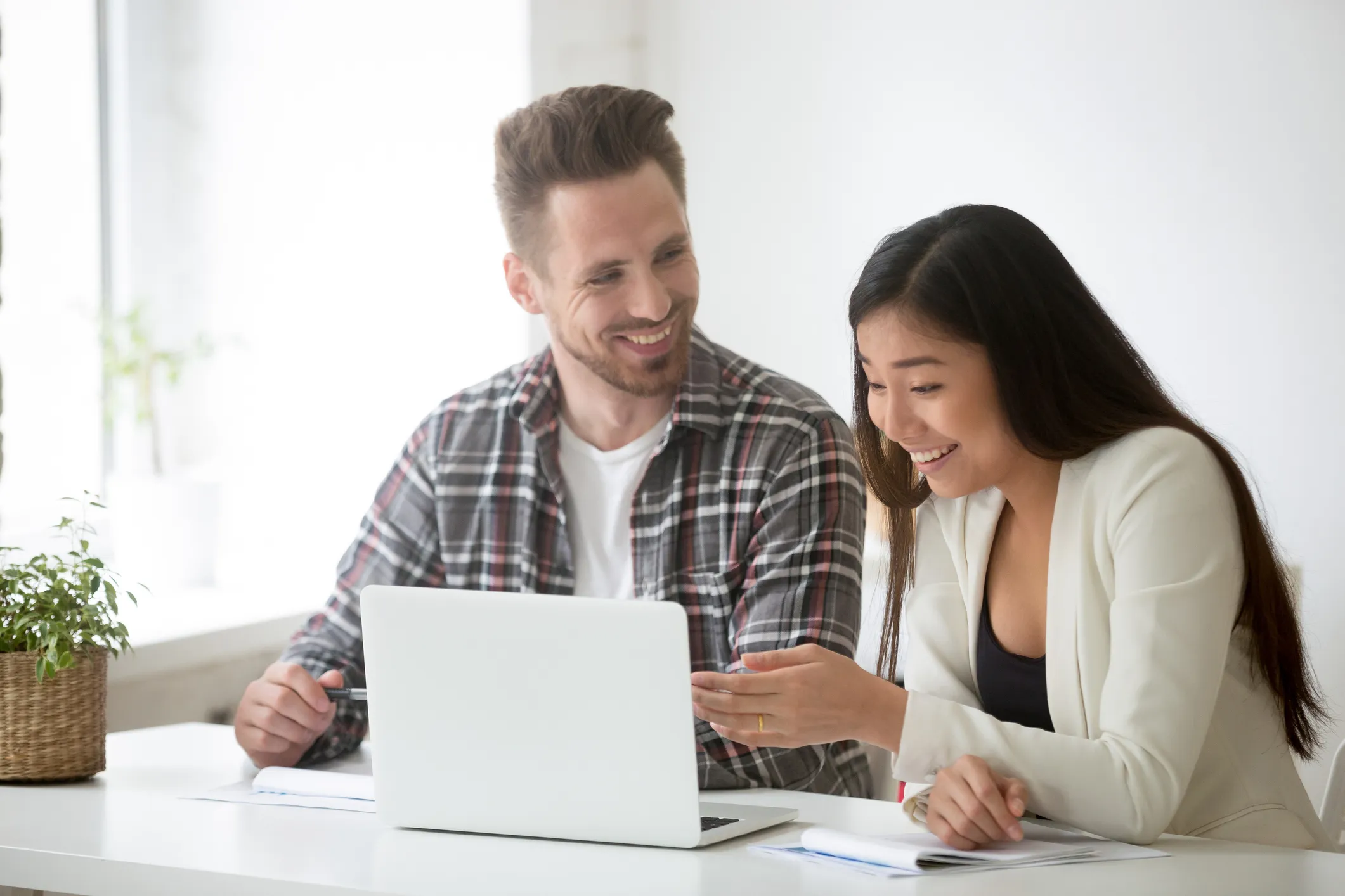 Two people reviewing information together at a laptop